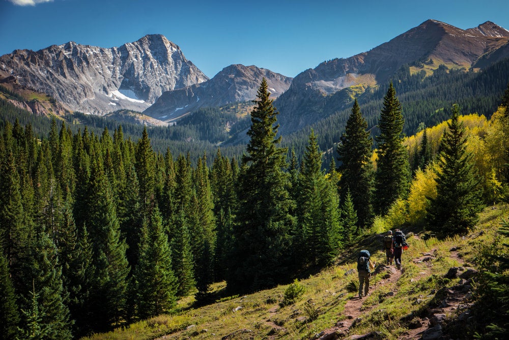 two hikers climbing capitol peak in colorado