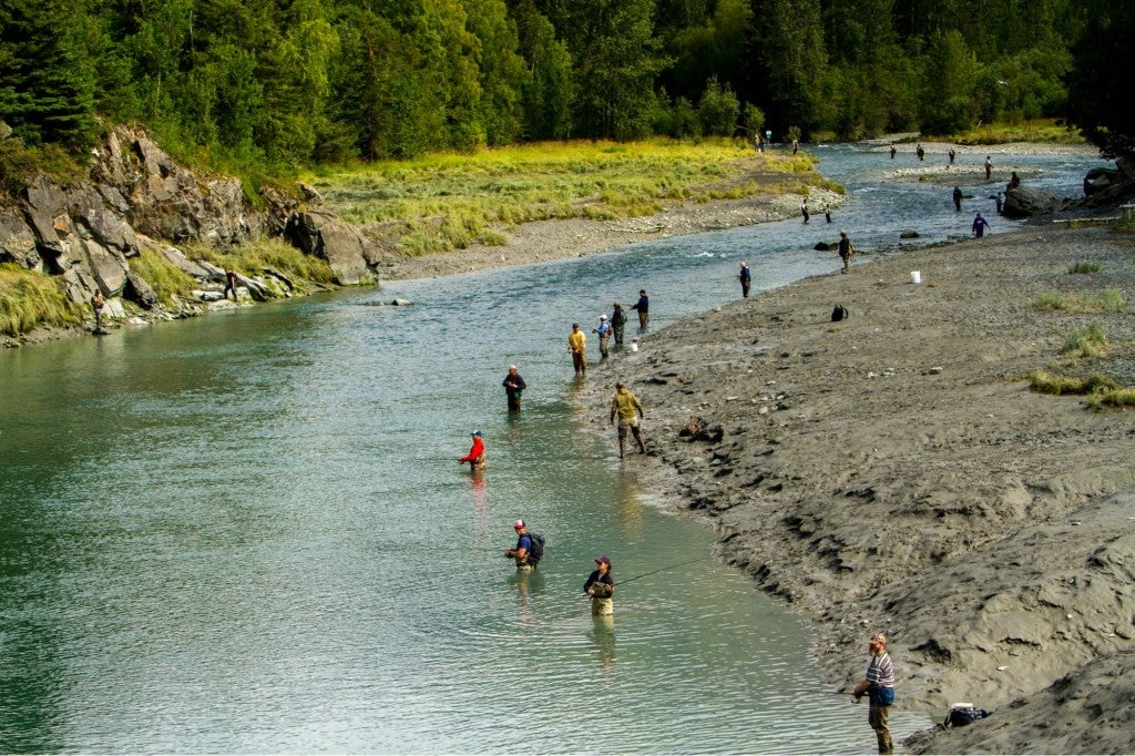 multiple people in the river on an alaska river fishing trip