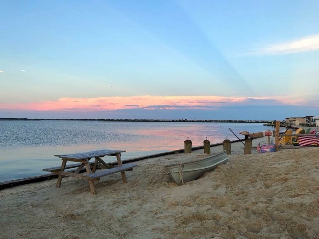 a beachfront on the atlantic ocean with a picnic table and fire ring in delaware