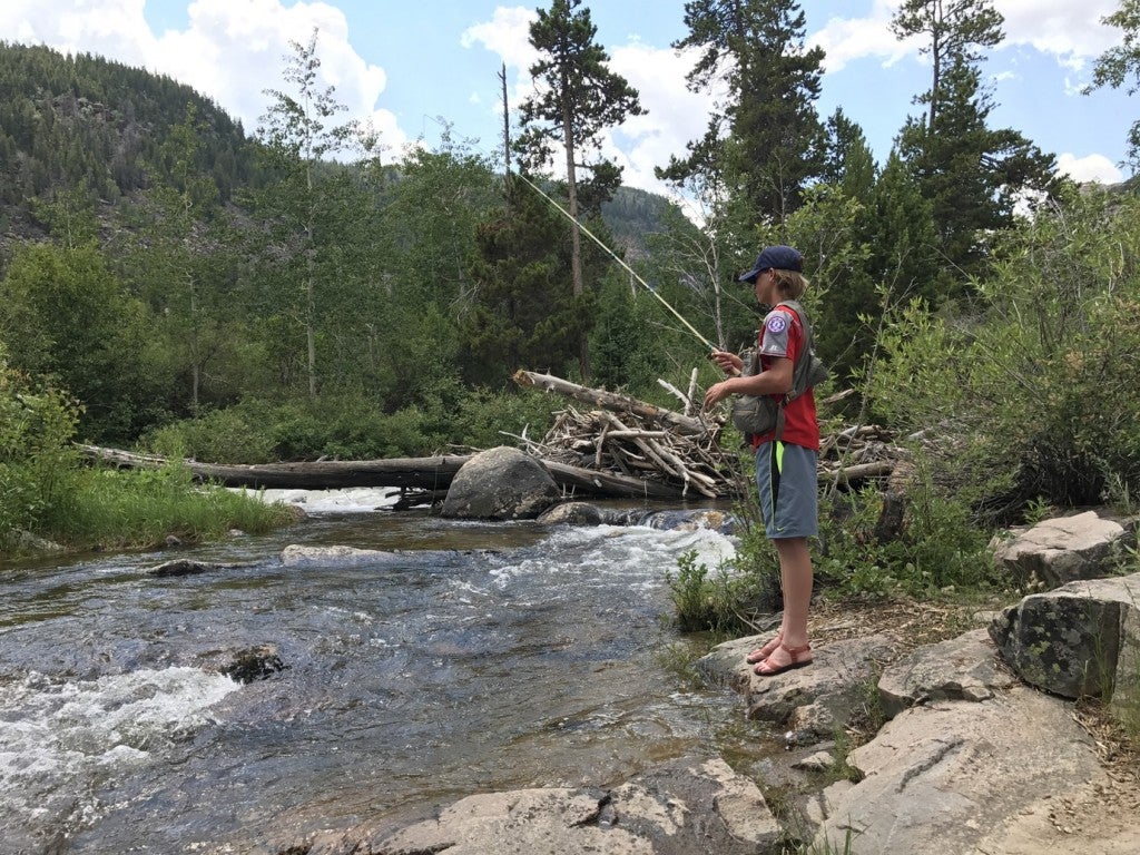 a teenager fishing in the popo agie river in wyoming
