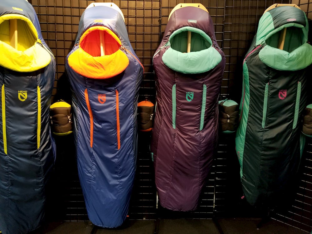 a row of nemo sleeping bags hanging on a wall