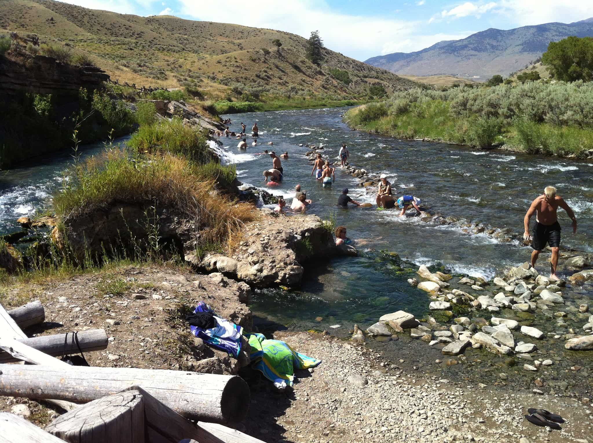 a river in wyoming with people swimming and along its banks