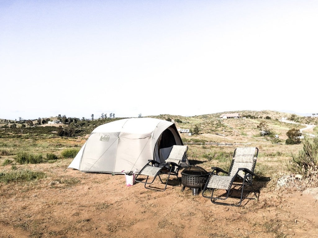 a scenic california countryside with a tent and two chairs