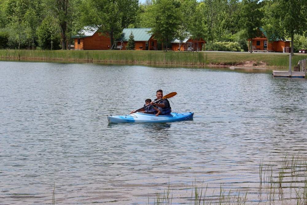 Father and daughter in lake on kayak 