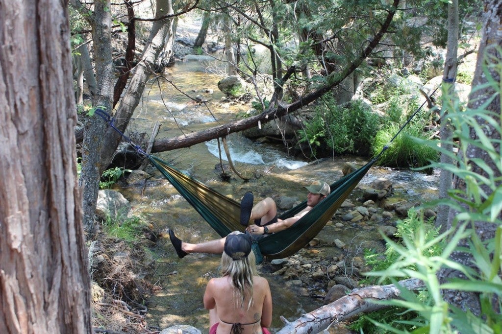 a person hanging in a Hammock over the kern river
