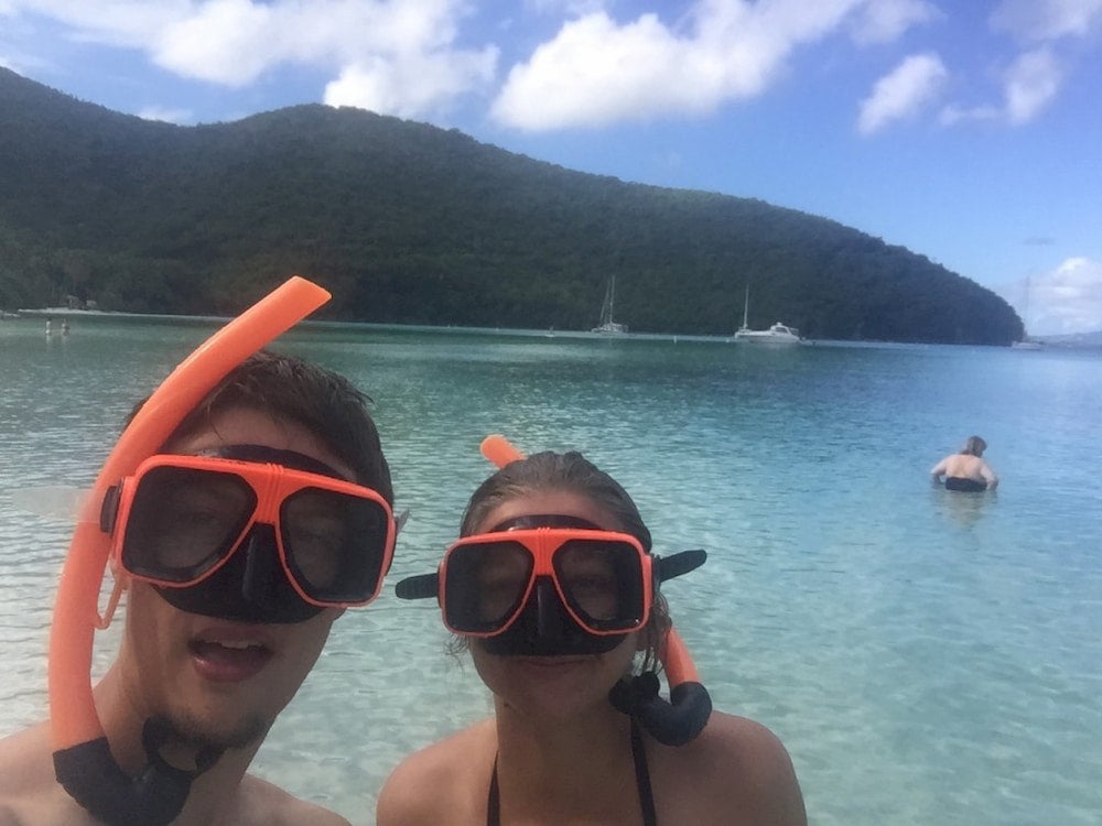 Two people with snorkel gear on. 