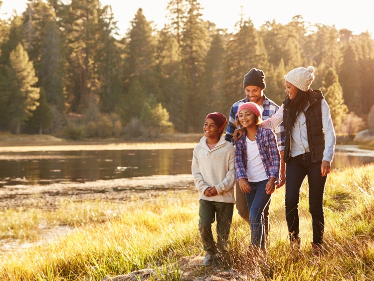 family hiking near lake