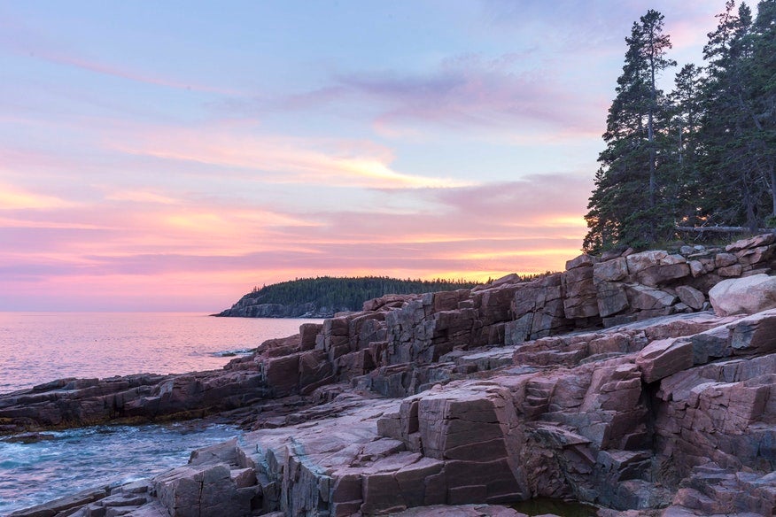 rocky shoreline colored blue and pink by the sunset near Blackwoods campground in Maine, photo from a camper on The Dyrt