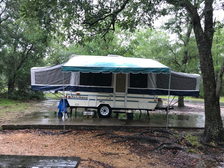 pop-up trailer set up in Buccaneer State Park campsite, photo from a camper on The Dyrt