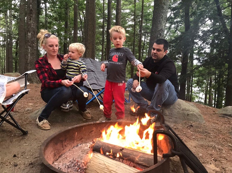 family of four roasts marshmallows at Pawtuckaway State Park campsite, photo from a camper on The Dyrt