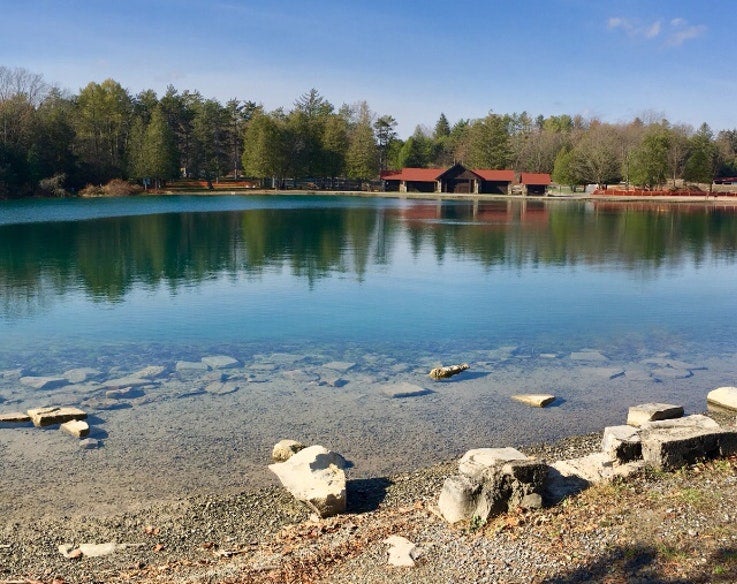 lodge visible across a calm Green Lake in New York state park, photo from a camper on The Dyrt