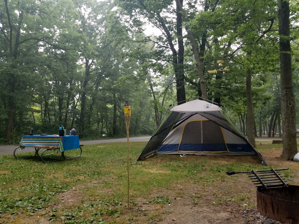 Tent at campground with trees in background 