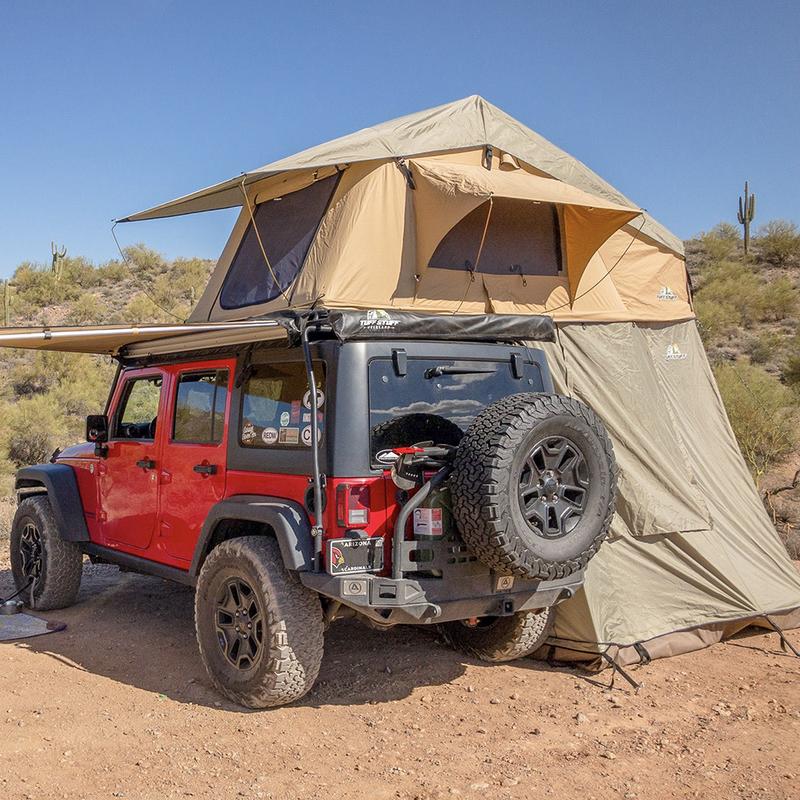 Red jeep with tent on top in desert 