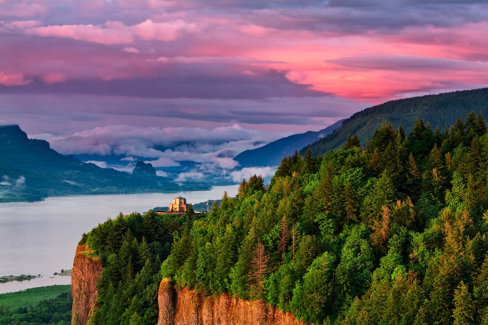 River with building on cliff during sunset 