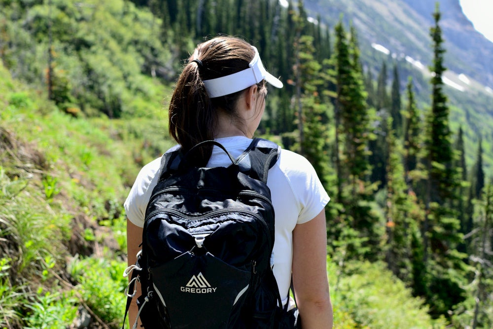 Women carrying day pack on the trail.