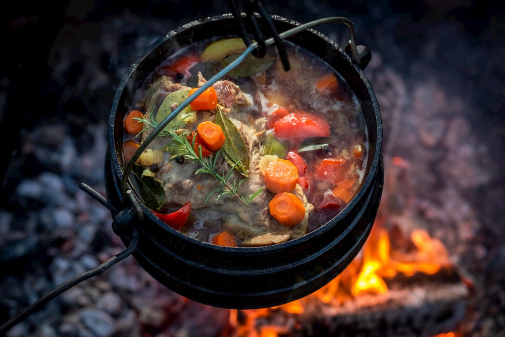 Hunter's stew in cast iron over a fire. 