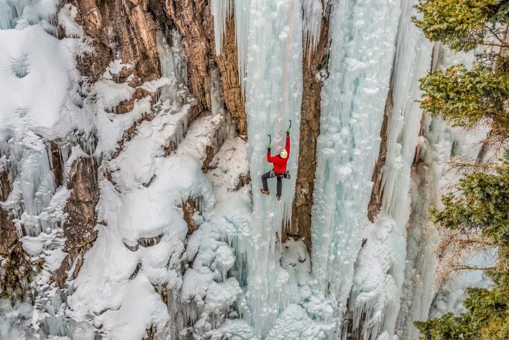 Ice climber scaling a frozen waterfall.