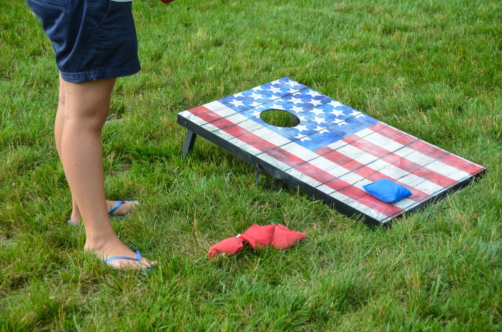 Person playing corn hole.