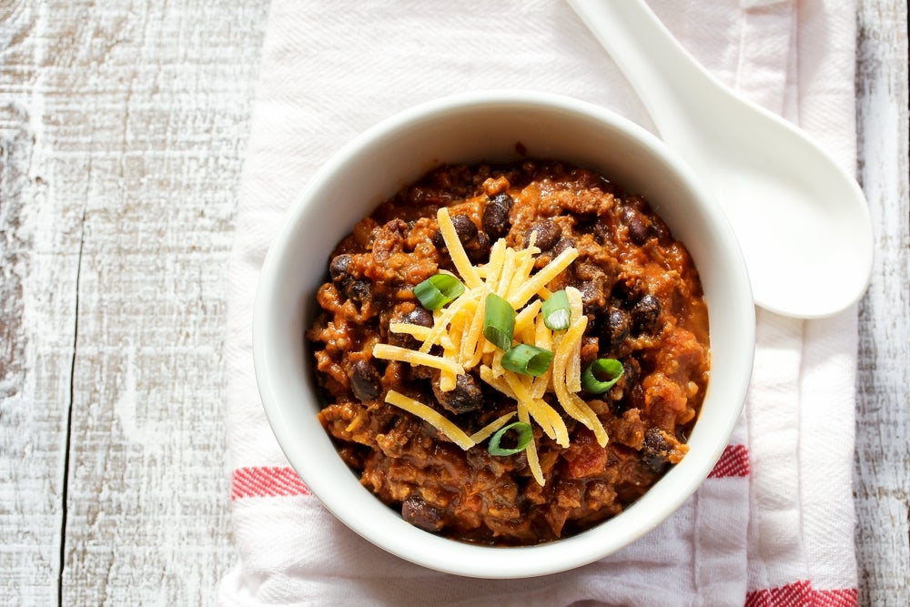 Chili in white bowl with cheese on top 