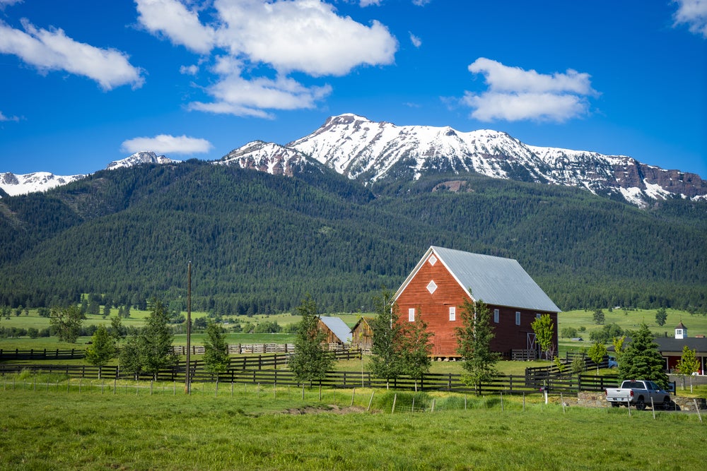 Wallowa mountains with red barn in foreground 