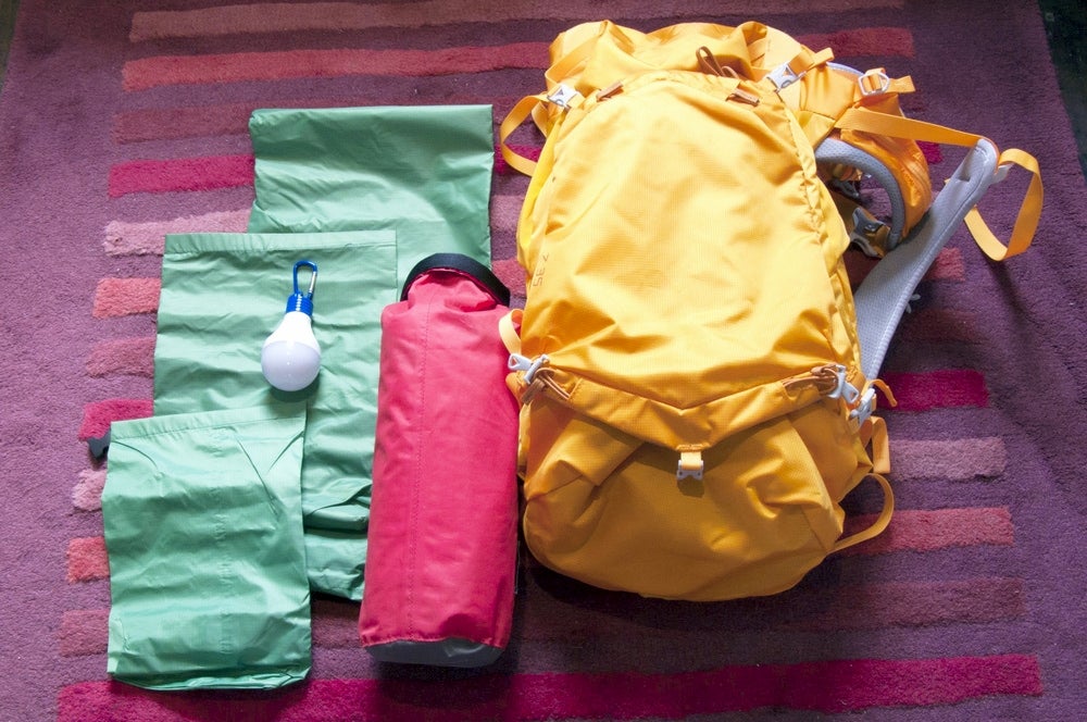 Backpacking gear with three excess stuff sacks.