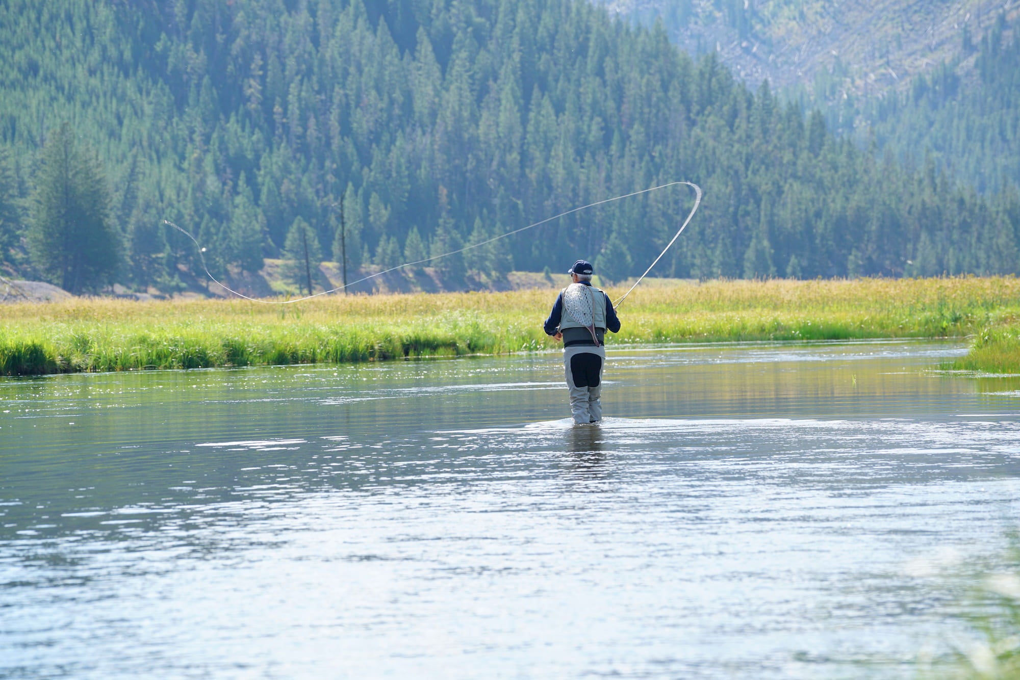 Man fly fishing on river in Wyoming