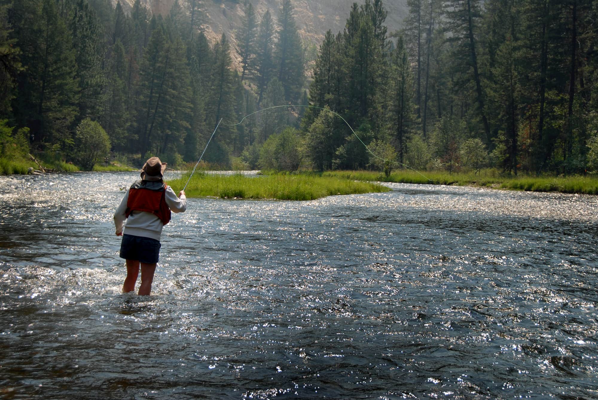 Woman fly fishing in Montana river