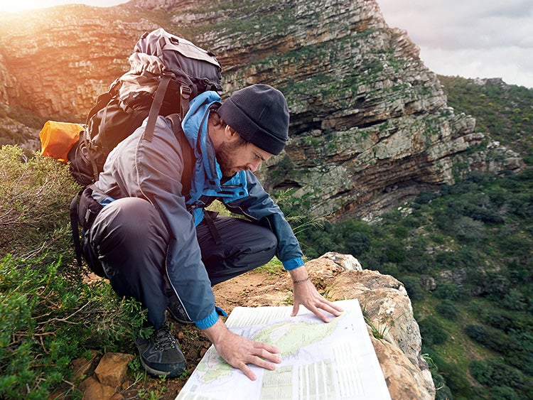 hiker with map in wilderness