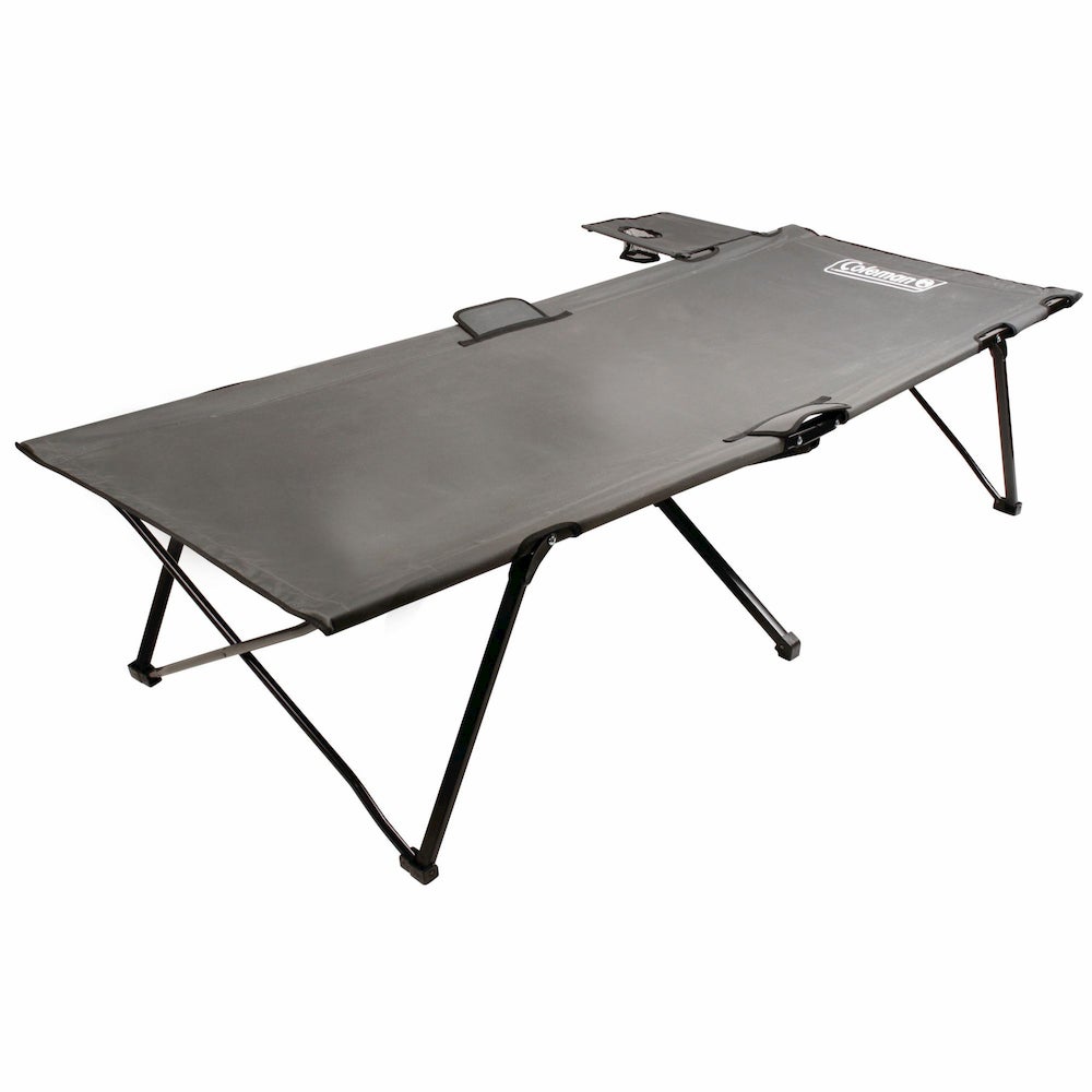 a grey camping cot with a fold out shelf from coleman