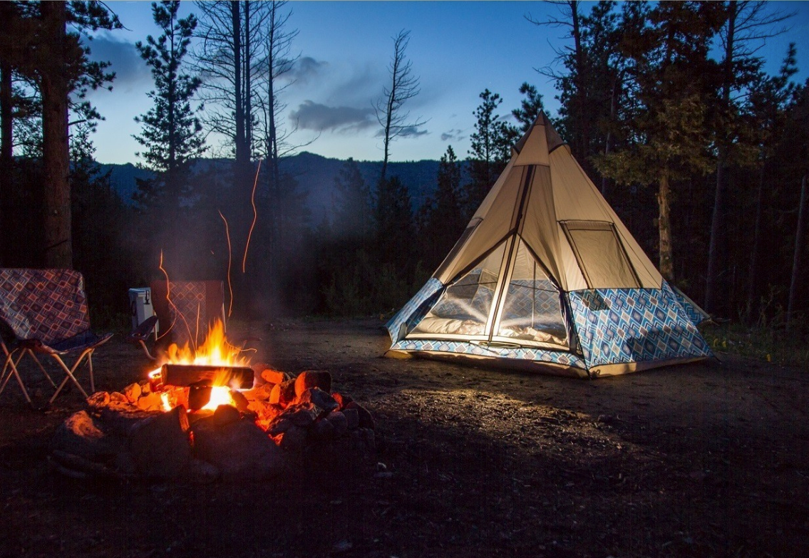 Wenzel tent beside campfire in the backcountry.