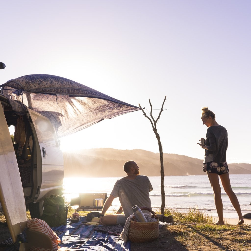 Couple using the Primus Tupike stove while car camping. 