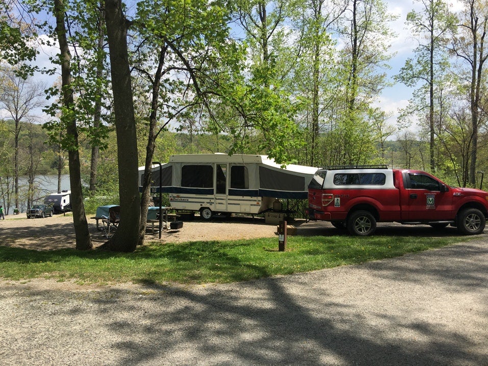 truck with travel trailer parked at lakefront campsite