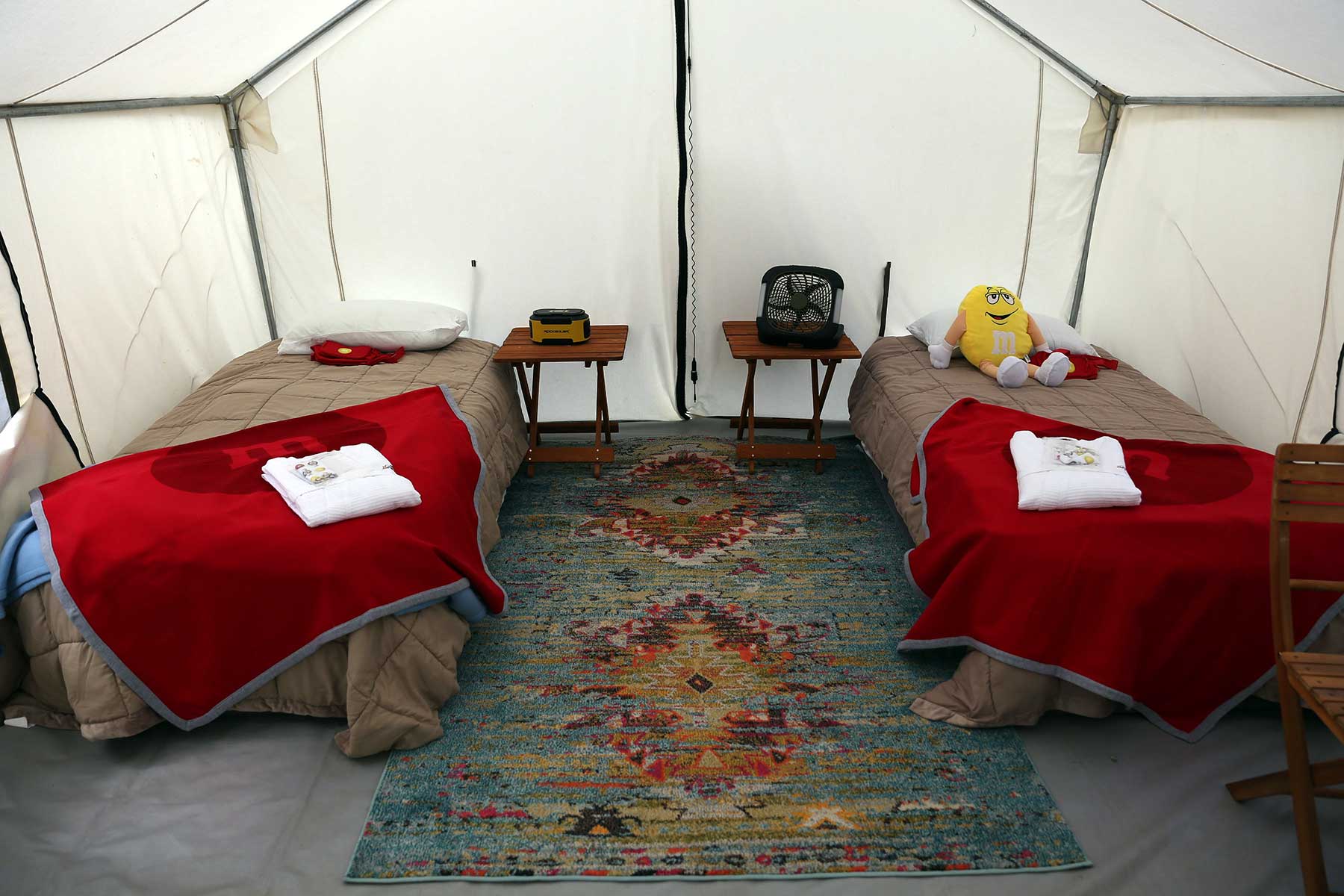 two beds in a glamping tent in a nascar track