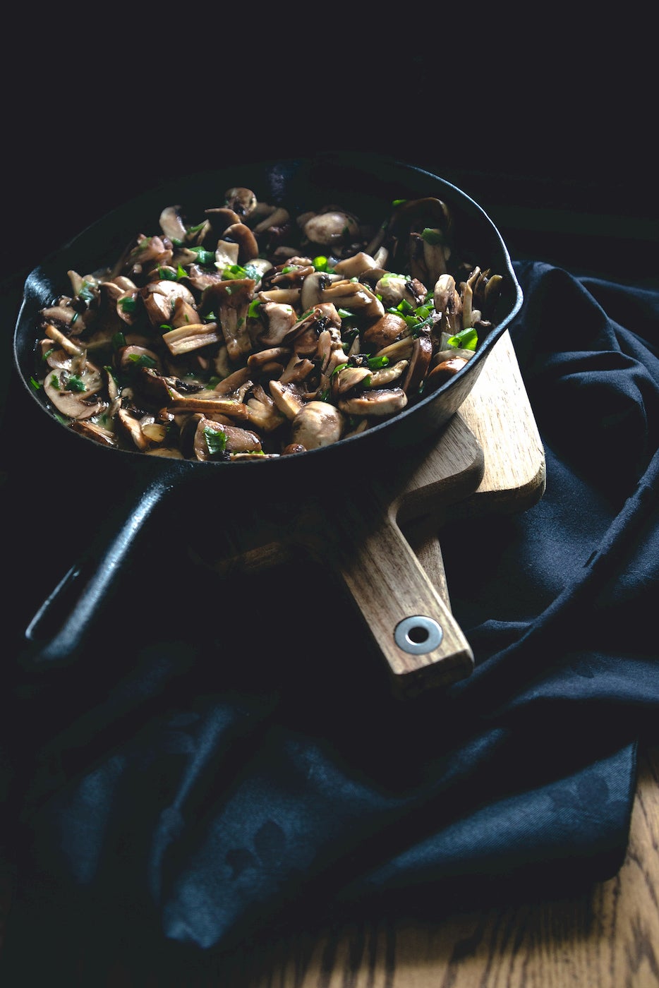 Sauteed mushrooms with herbs in a cast iron.