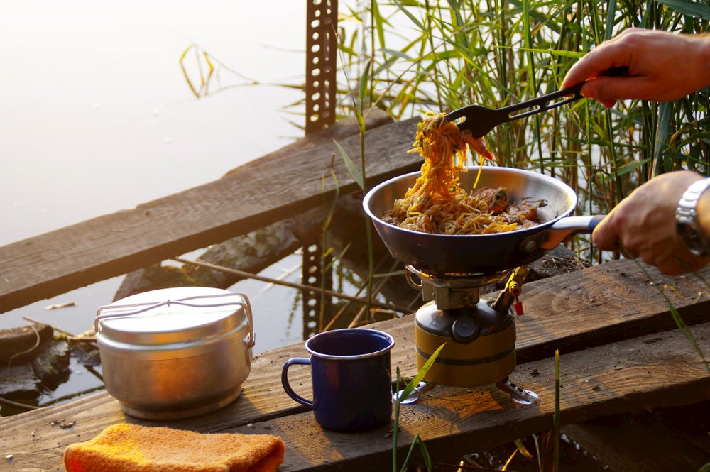 Spaghetti in a pan with lake in background 