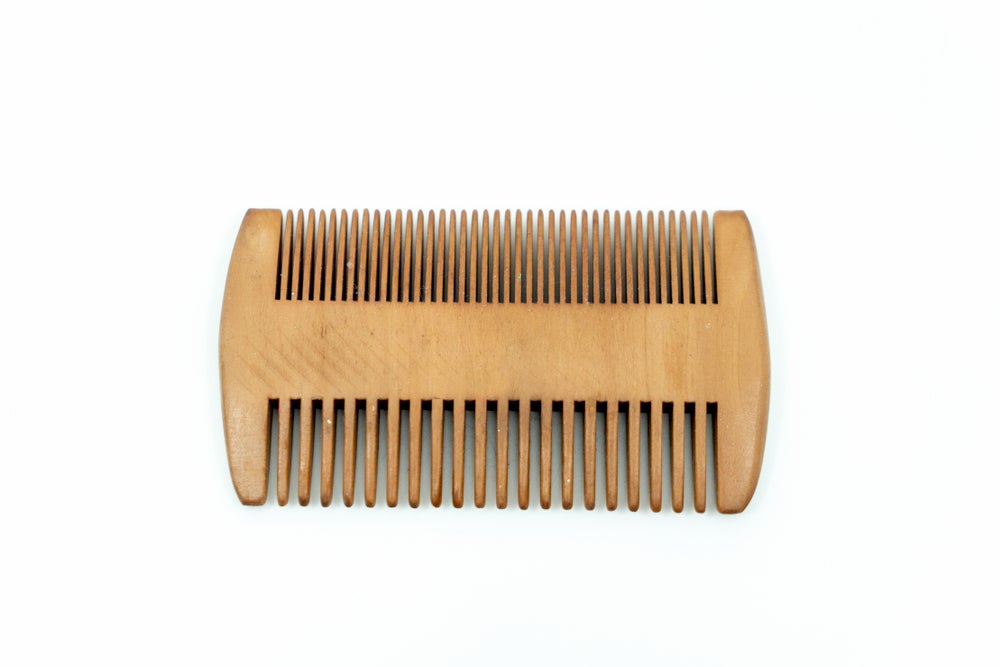 Wooden dual beard comb.