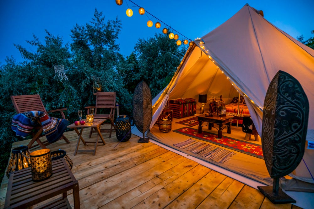 Tent with lights on wooden deck 