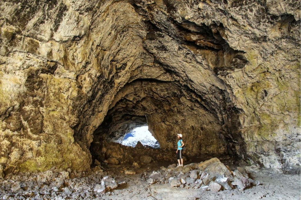 a woman in the mouth of a large crater in idaho