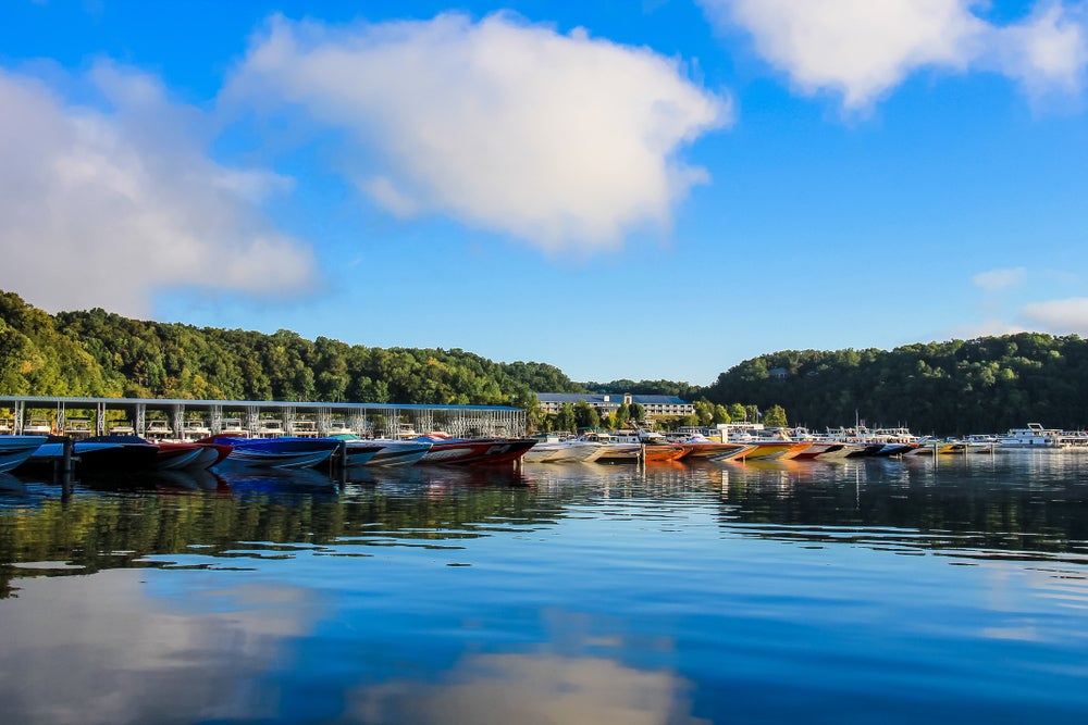 Blue lake with colorful boats along the lake