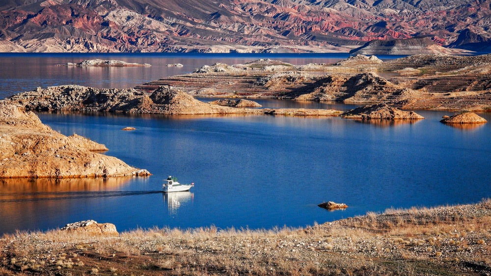 Lake with red rocks in background