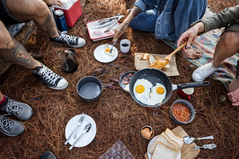 Spread of breakfast including eggs and beans while camping 