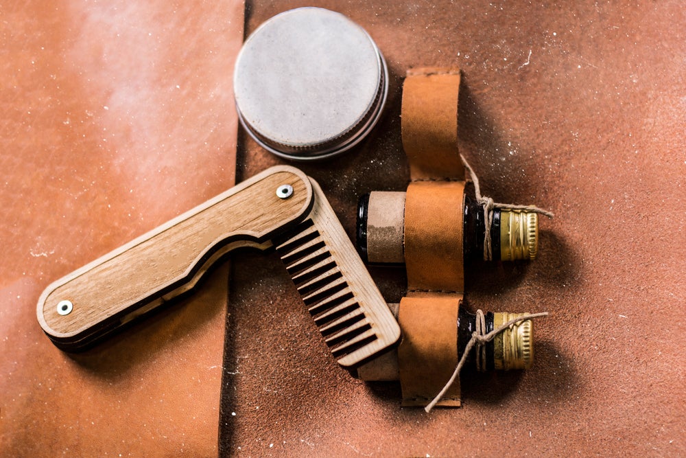 Bear oil and comb in leather travel beard kit.