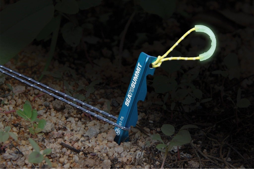 a sea to summit tent peg in the ground 