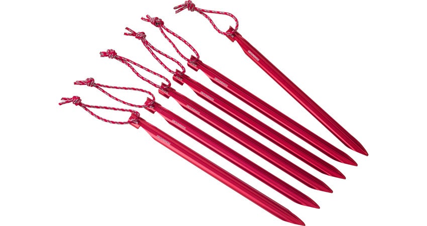 a row of five tent stakes