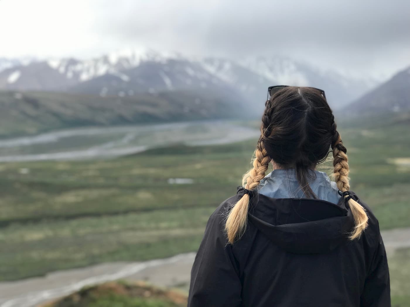 Female hiker in Denali backcountry wearing a black Red Ledge jacket.