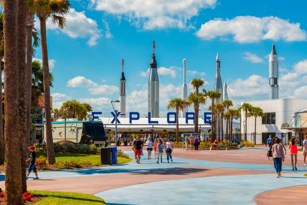 the kennedy space center in cape canaveral florida as people walk around space rockets