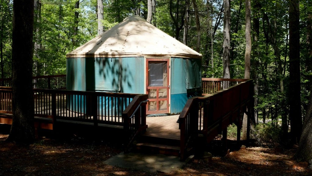 Yurt with porch in the middle of the forest.