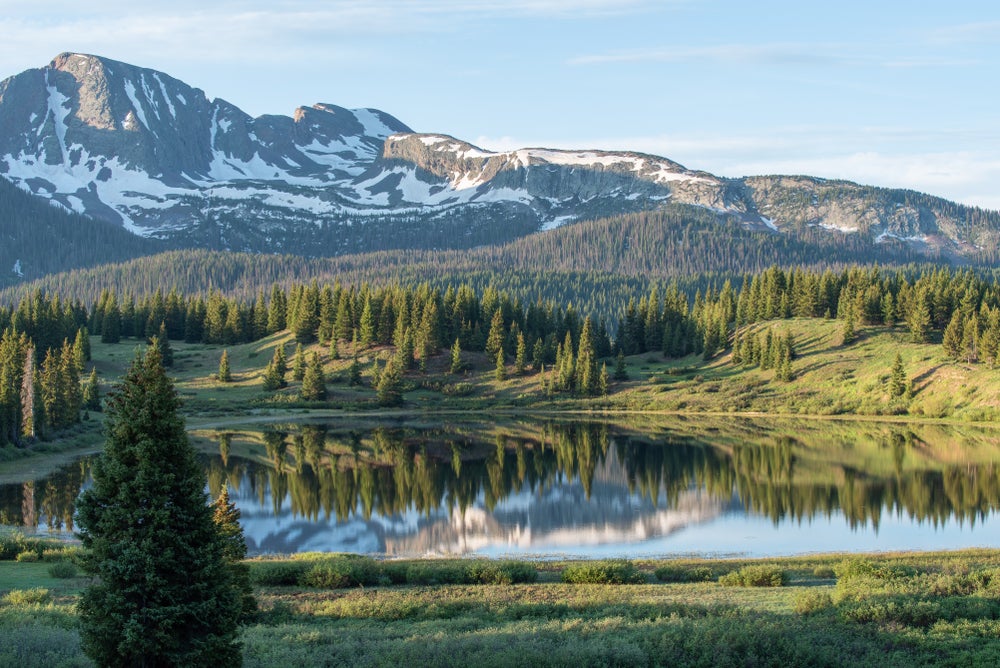 Snowcapped mountain above landscape of Little Molas Lake.