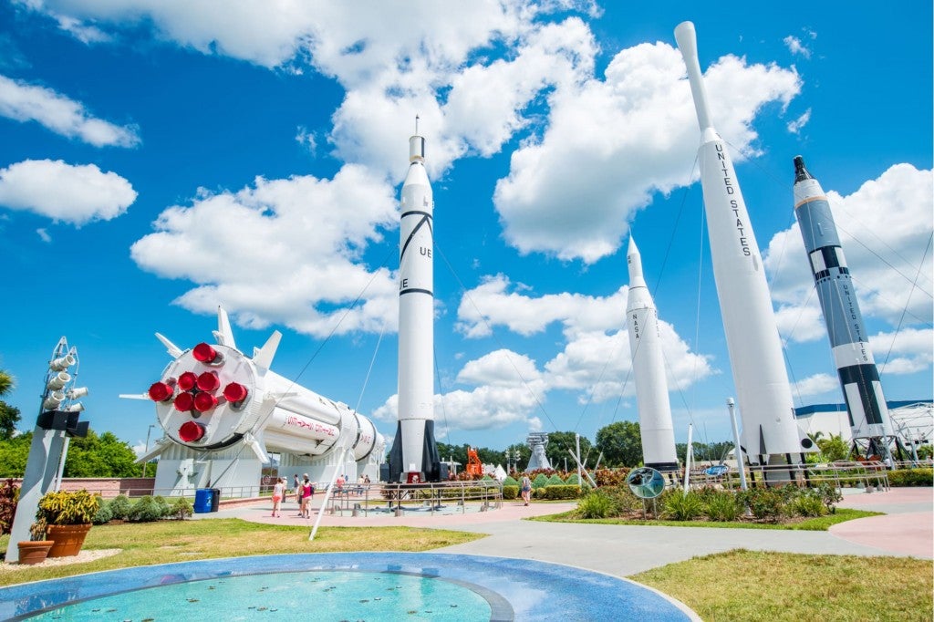 five rockets in a garden at the nasa center in cape canaveral florida