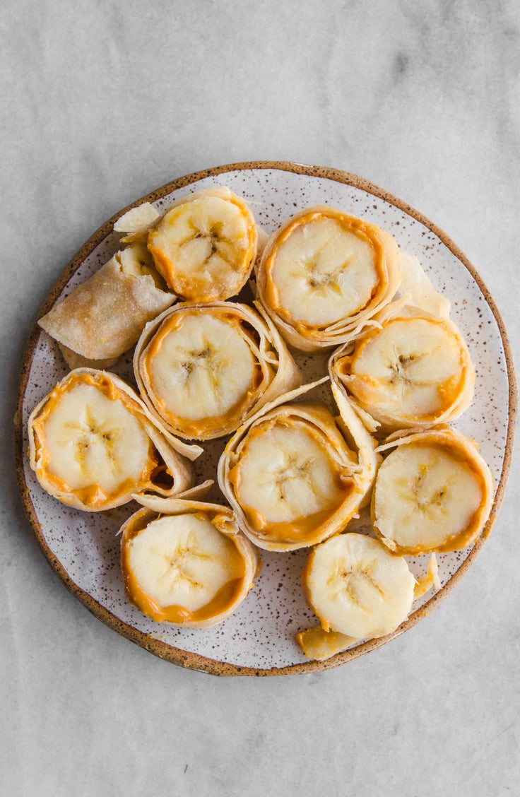 a plate of peanut butter and banana roll ups